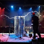 Members-Of-Arc-Attack-Watch-As-Lightning-Strikes-A-Faraday-Cage-At-Maker-Faire-2012-Audiopolitan
